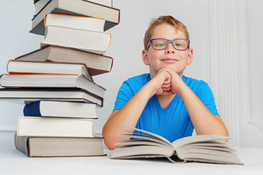 child at school with many books trying to learn. Amount of educational material in school library - concept.