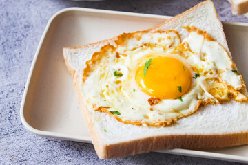 Close-up of a dish of fried eggs on toast, as a breakfast menu