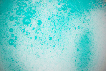 Foam in blue water. Blue foam. Water with foam bubbles. Blue background