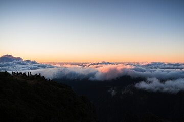 Tourists watch the sunrise from Pico Areeiro