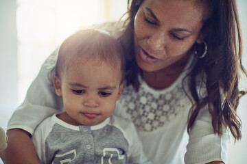 Happy, mom and baby in home with love, maternal or nurturing care and support for growth or...