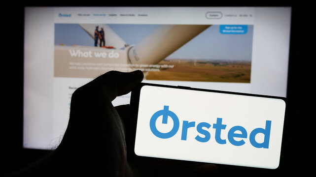 Stuttgart, Germany - 08-12-2024: Person holding cellphone with logo of Danish wind energy company Orsted AS in front of business webpage. Focus on phone display.