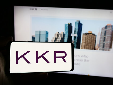 Stuttgart, Germany - 08-13-2024: Person holding smartphone with logo of US investment company KKR Co. Inc. in front of website. Focus on phone display.