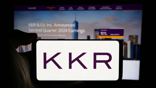 Stuttgart, Germany - 08-13-2024: Person holding cellphone with logo of US investment company KKR Co. Inc. in front of business webpage. Focus on phone display.