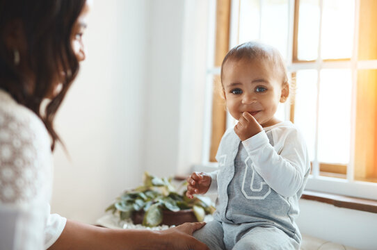 Happy, mom and baby on counter with love, maternal or nurturing care and support for growth or development. Mother, boy toddler and together in home for bonding, emotional connection and wellness.