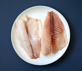 Fillet of tilapia or Saint Peter fish Oreochromis niloticus. Isolated on white background