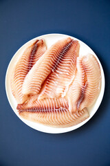 Fillet of tilapia or Saint Peter fish Oreochromis niloticus. Isolated on white background