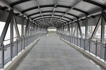 Pedestrian pathway or corridor or hallway between train station and other building.