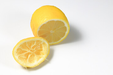 fresh with cut half and squeezed lemon fruit isolated on white background.
