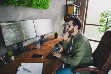 Photo of successful intelligent thoughtful man developer expert wear shirt work with operating...