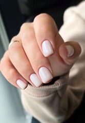 The beauty of the natural nails. Perfect clean manicure. New trendy nail arts on young women hand