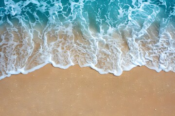 A top down aerial view of beach shoreline gentle waves on a sandy beach in australia