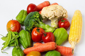 Assorted fresh vegetables on isolated white background, showing various colors and textures