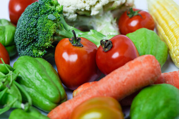 Assorted fresh vegetables on isolated white background, showing various colors and textures