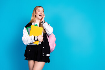 Photo of cheerful glad adorable girl wear stylish outfit hand face wow offer sale empty space isolated on blue color background