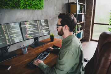 Photo of successful handsome man developer expert wear shirt work with modern technology operating system server pc indoors