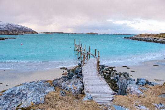 Sommaroy islands and arctic sea near Tromso Norway. Sunset over snowy small islands