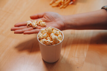 A woman holding a bowl of popcorn