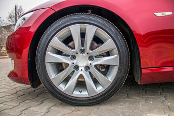 Gray rim of a red car wheel close-up 