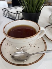 The perfect atmosphere for breakfast in the cafe. Vintage ceramic mug with hot aromatic tea. The feeling of romance and tranquility in the cafe
