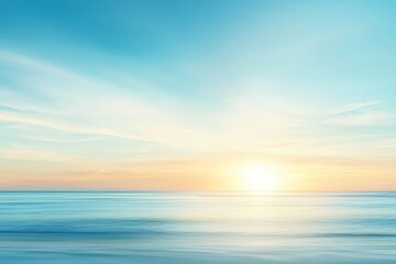 Obraz premium A serene ocean view at sunrise, featuring vibrant colors of blue and orange blending beautifully in the sky and water.