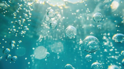 A close-up shot of air bubbles rising through clear, turquoise water, illuminated by sunlight