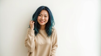 Jovial woman in cream pullover leans on white backdrop 