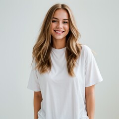 Fototapeta premium Joyful woman with long hair donning white t-shirt light background 