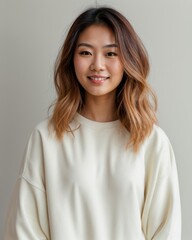 Fototapeta premium Lady with messy hair in white pullover against calm backdrop 