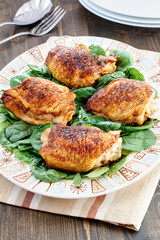 Buttered Garlic Chicken Thighs on a bed of spinach