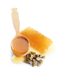 Sweet honeycomb, spoon and propolis granules isolated on white