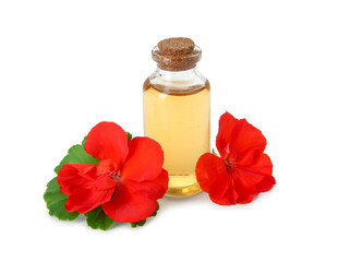 Bottle of geranium essential oil and beautiful flowers isolated on white