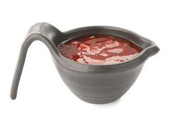 Hot chili sauce in gravy boat isolated on white