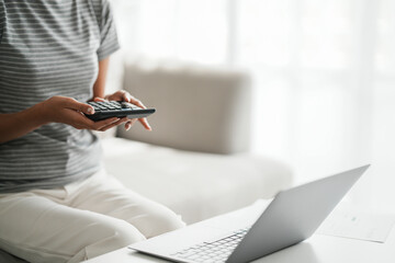 Fototapeta premium Female calculating personal financial for future plan at her home, taxes payment