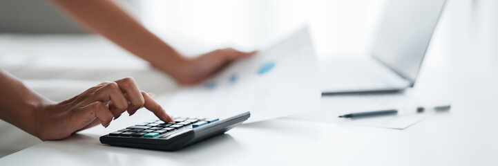 Female calculating personal financial for future plan at her home, taxes payment