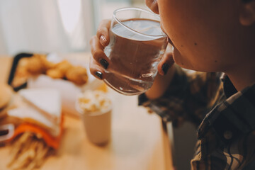 healthy beautiful young woman holding glass of water