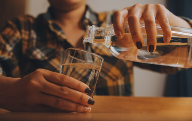healthy beautiful young woman holding glass of water