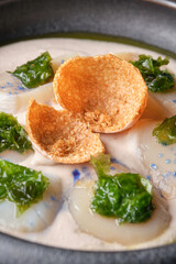 Delicious cream soup with scallop and crispy cheese chips