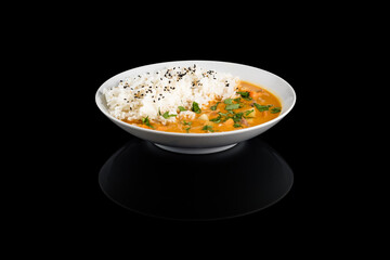Asian curry with white rice garnished with herbs
