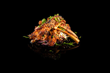 Asian-style roasted ribs on a black background