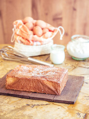 Freshly baked sponge cake on rustic kitchen table