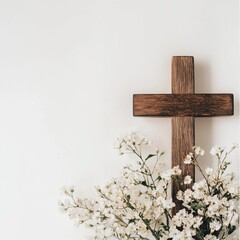 Naklejka premium Rustic wooden cross with white flowers against a minimalist white background