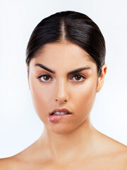Obraz premium Portrait, girl and biting lip for beauty, skincare and cosmetics for glow, dermatology or white background. Female person, seductive and cosmetology for anti aging, confidence and pride as sexy model