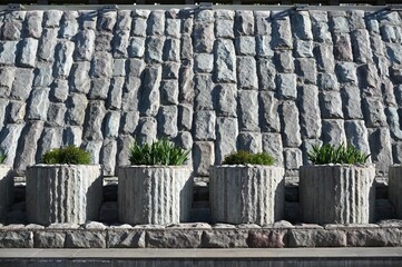 Flower pedestals and a parapet decorated with white granite, with irises planted in the pedestals. © Colobus