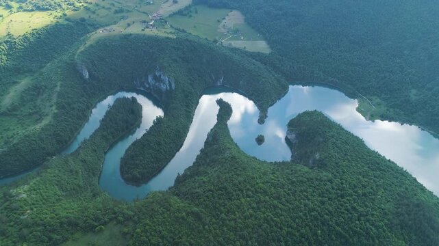 aerial view of a picturesque river meandering among the hills