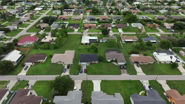 Large Real Estate houses with property in Florida. Exclusive american neighborhood with straight lined streets. Aerial birds eye flight.