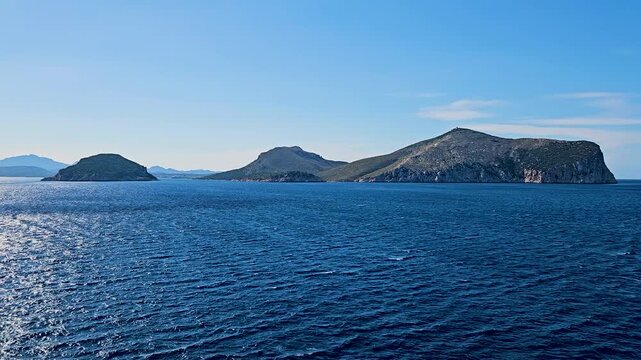 The ship sails along an archipelago of islands with calm seas