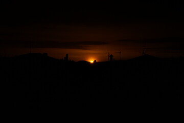 Sun covered by clouds at sunset. The sky seems like a work of art imbued with mystery, sadness and...