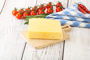 Piece of natural organic cheese over board