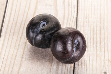 Two ripe sweet black plums